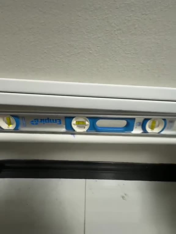 Water lines run along the wall, checked with a spirit level