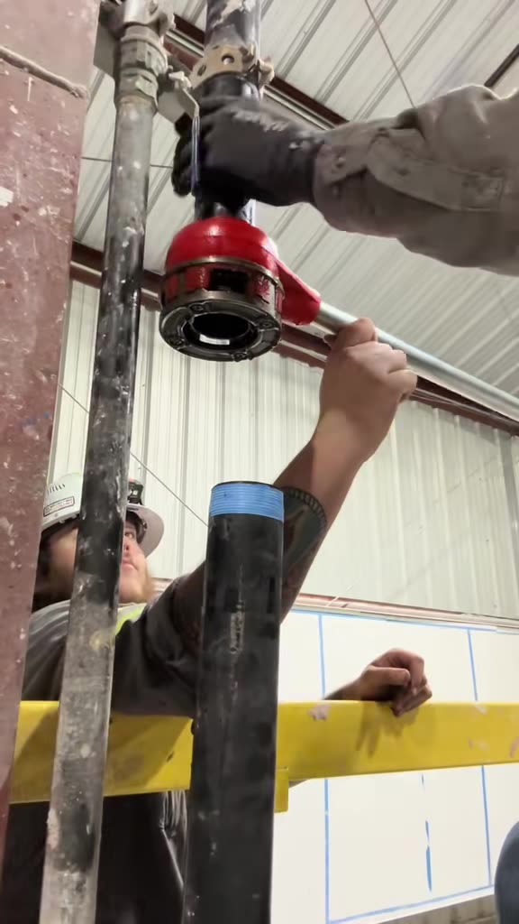 Torquing a fitting on overhead pipe